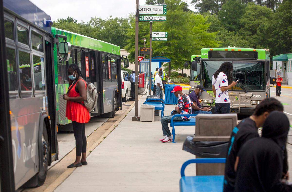 Passengers and bus drivers prepare to board their buses at the GoTriangle Regional Transit Center in Durham, N.C. 