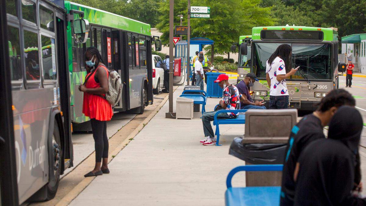 Passengers and bus drivers prepare to board their buses at the GoTriangle Regional Transit Center in Durham, N.C. 