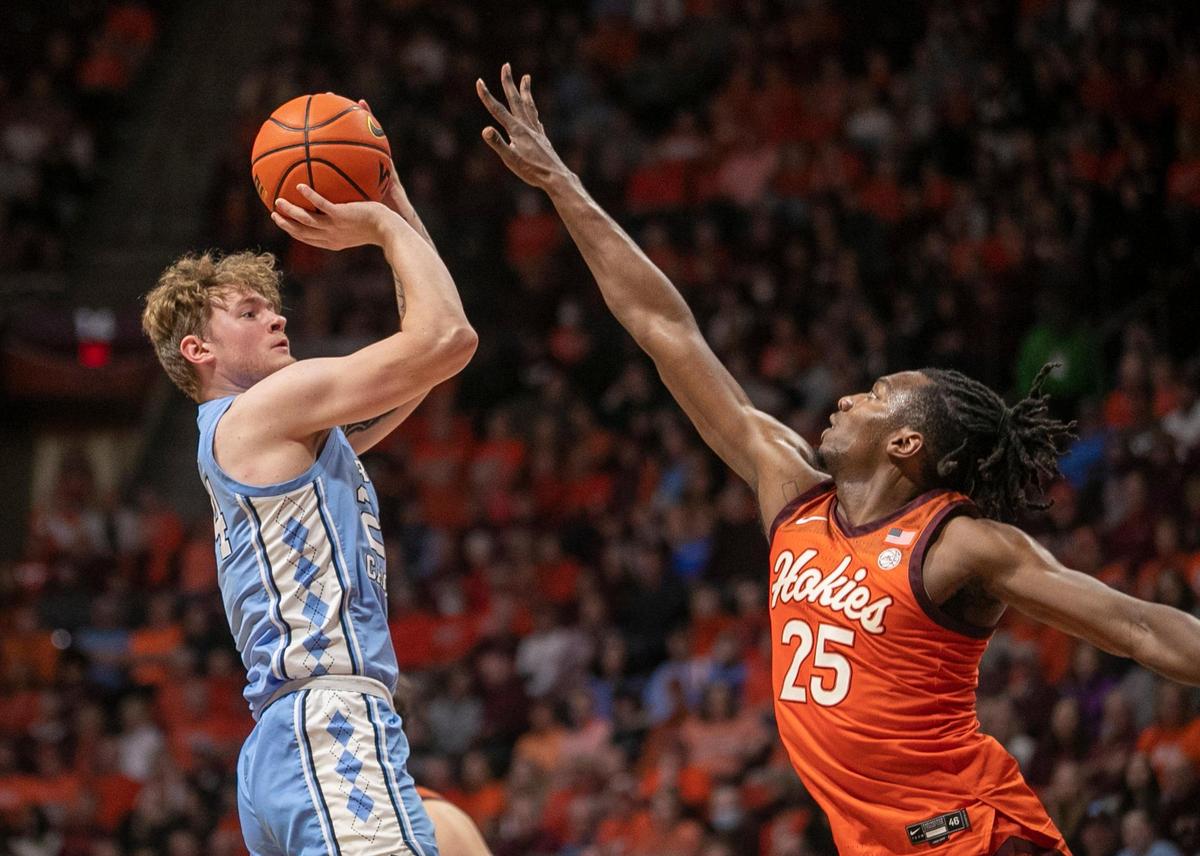 North Carolina’s Tyler Nickel (24) puts up a shot against Virginia Tech’s Justyn Mutts (25)) during the second half on Sunday, December 4, 2022 at Cassell Coliseum in Blacksburg, Va. Nickel scored eight points.