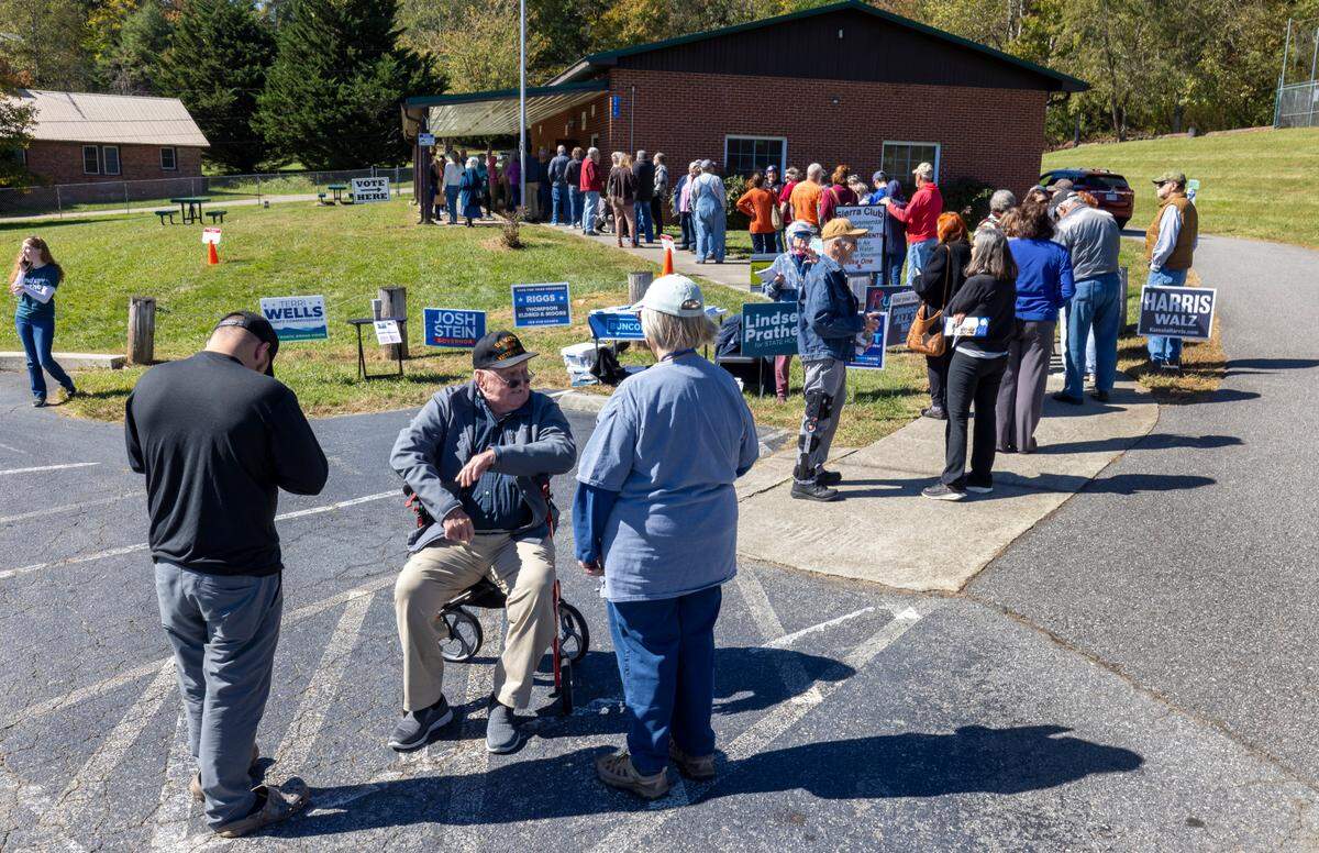 Voters wait in line to cast their ballots on the first day of early voting, on Oct. 17, 2024, at the Leicester Community Center in Leicester.