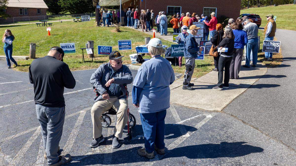 Voters wait in line to cast their ballots on the first day of early voting, on Thursday, October 17, 2024, at the Leicester Community Center in Leicester, N.C.