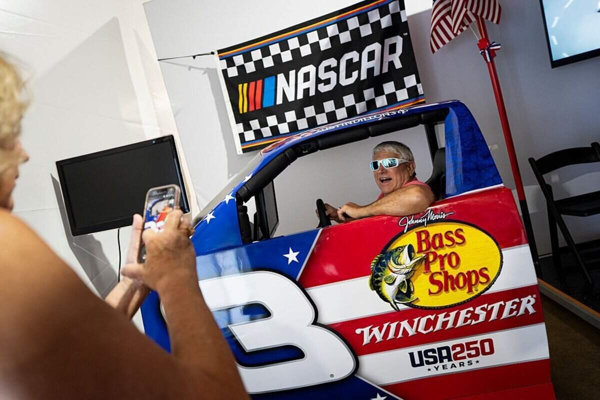 WASHINGTON, DC - JUNE 25: A visitor poses for a photo in a NASCAR display at the North Carolina exhibit on the first day of the "Great American State Fair" on the National Mall on June 25, 2026 in Washington, DC. The Freedom 250-backed Great American State Fair celebrating the 250th anniversary of the United States runs through July 10th. (Photo by Al Drago/Getty Images)