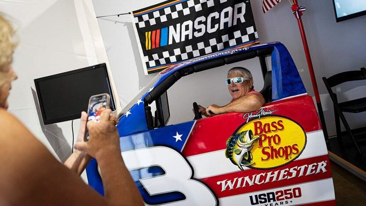 WASHINGTON, DC - JUNE 25: A visitor poses for a photo in a NASCAR display at the North Carolina exhibit on the first day of the "Great American State Fair" on the National Mall on June 25, 2026 in Washington, DC. The Freedom 250-backed Great American State Fair celebrating the 250th anniversary of the United States runs through July 10th. (Photo by Al Drago/Getty Images)
