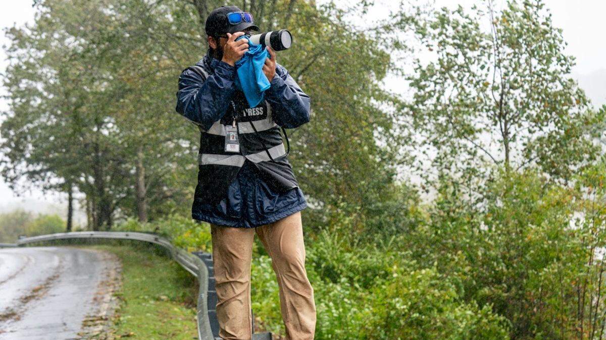A Blue Ridge Public Radio journalist photographs the Western North Carolina landscape from the road side after Hurricane Helene ravaged WNC.