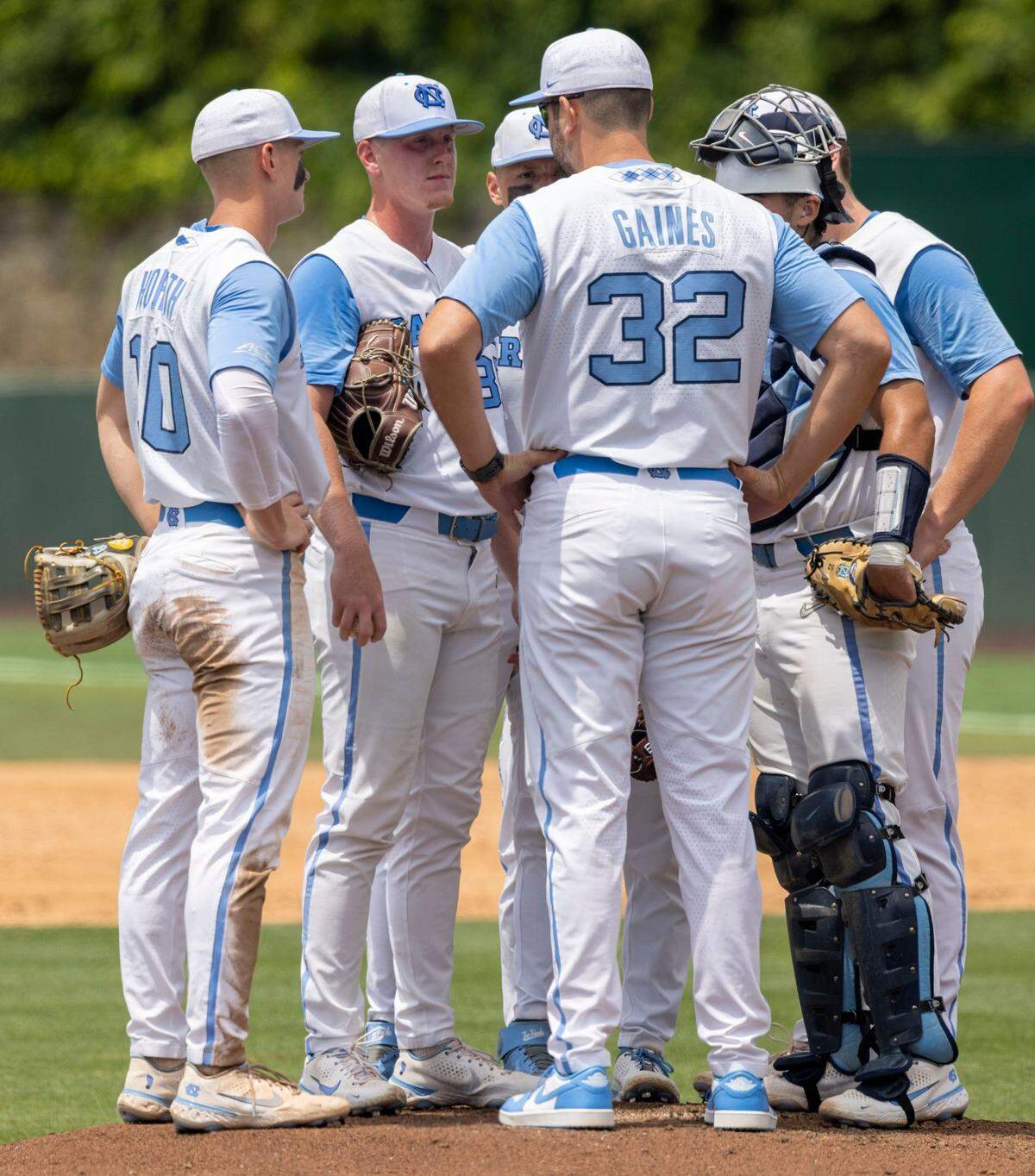 North Carolina coach Bryant Gaines confers with North Carolina starting pitcher Max Carlson (35) in the fifth inning against Arkansas during the first game of their Super Regional series on Saturday, June 11, 2022 at Boshamer Stadium in Chapel Hill, N.C.