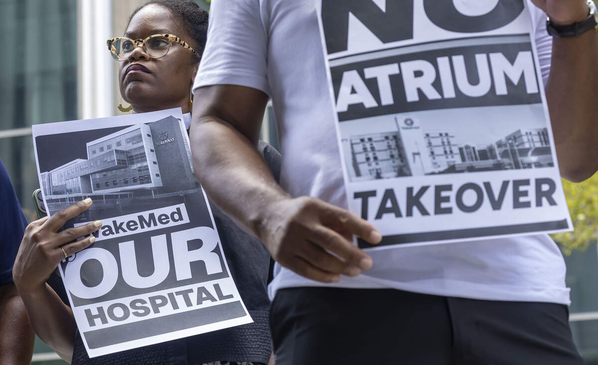 Rev. Hershey Mallette Stephens displays her disapproval to the proposed WakeMed, Atrium merger, outside the Wake County Justice Center on Monday, July 6, 2026 in Raleigh, N.C.