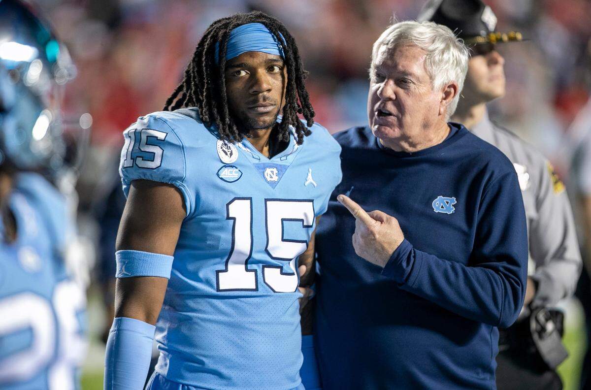 North Carolina coach Mack Brown scolds (15) ‘Dae Dae’ Hollins after an altercation following the Tar Heels’ 30-27 loss to N.C.State on Friday, November 25, 2022 at Kenan Stadium in Chapel Hill, N.C.