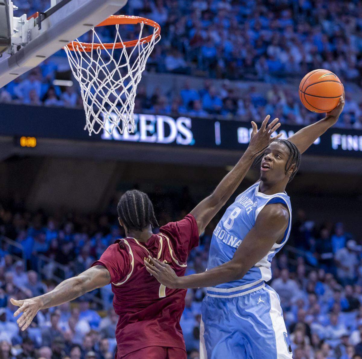 North Carolina forward Caleb Wilson (8) breaks to the basket for a dunk against Florida State forward Chauncey Wiggins (7) in the second half on Tuesday, December 30, 2025 at the Smith Center in Chapel Hill, N.C. Wilson lead all scores with 22 points in the Tar Heels’ 79-66 victory. 