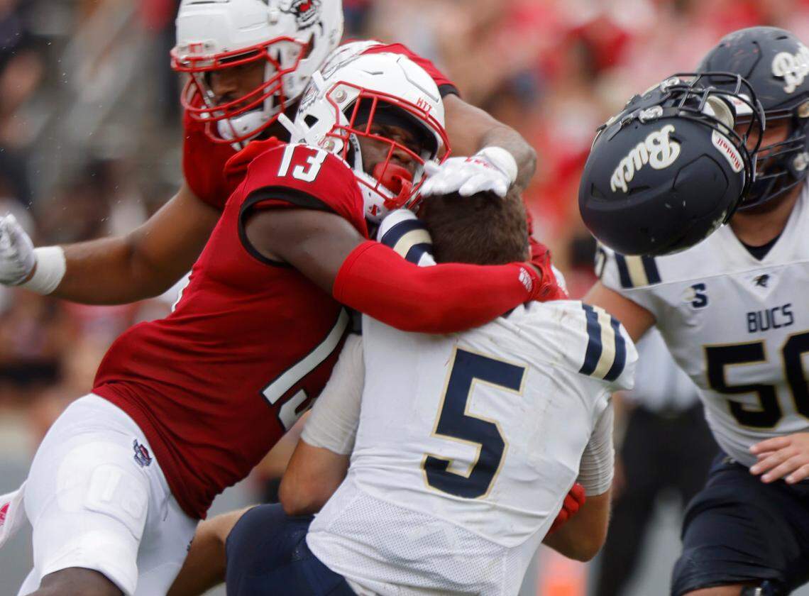N.C. State defensive back Tyler Baker-Williams hits Charleston Southern quarterback Ross Malmgren, causing him to fumble the ball during the second half of the Wolfpack’s game against Charleston Southern on Saturday, Sept. 10, 2022, at Carter-Finley Stadium in Raleigh, N.C.