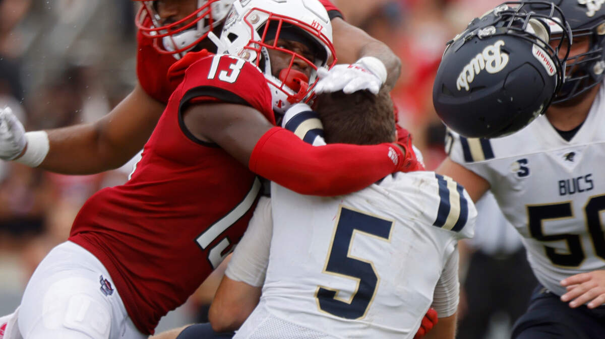 N.C. State defensive back Tyler Baker-Williams hits Charleston Southern quarterback Ross Malmgren, causing him to fumble the ball during the second half of the Wolfpack’s game against Charleston Southern on Saturday, Sept. 10, 2022, at Carter-Finley Stadium in Raleigh, N.C.