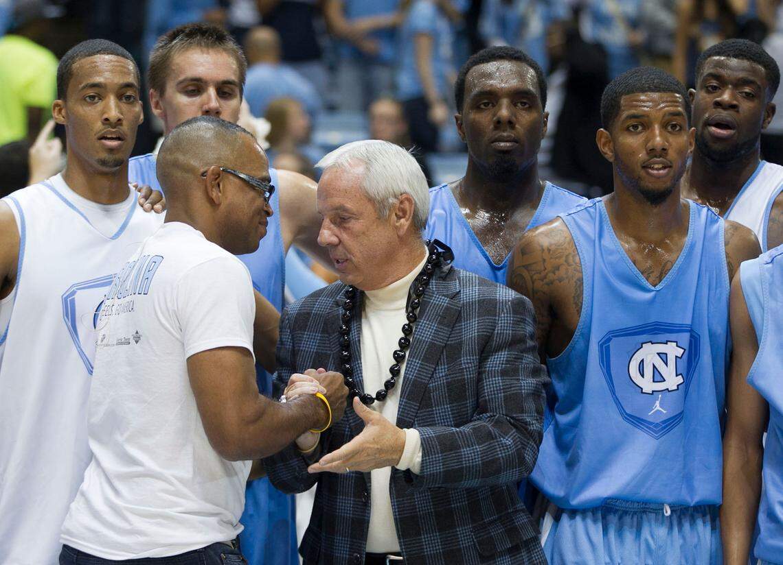 UNC coach Roy Williams shakes hands with ESPN’s Stuart Scott following the annual “Late Night with Roy Williams” kick off to the 2012 basketball season on October, 12, 2012 at the Smith Center in Chapel Hill, N.C.