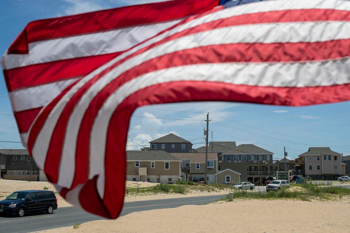The American Flag is whipped by the wind along NC 12 at the Cape Hatteras Motel on Thursday, July 1, 2021 in Buxton, N.C.