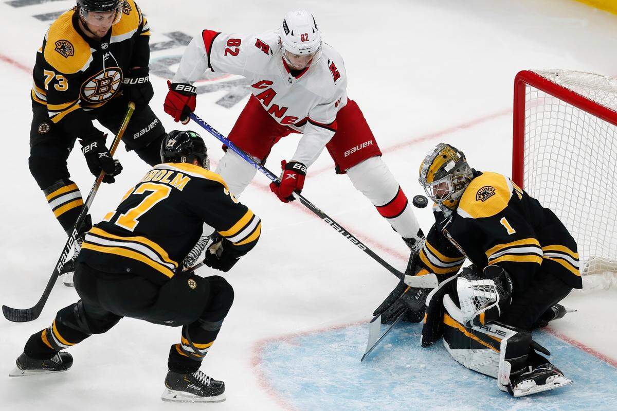 Boston Bruins goaltender Jeremy Swayman (1) blocks a shot by Carolina Hurricanes’ Jesperi Kotkaniemi (82) during the second period in Game 6 of an NHL hockey Stanley Cup first-round playoff series Thursday, May 12, 2022, in Boston.