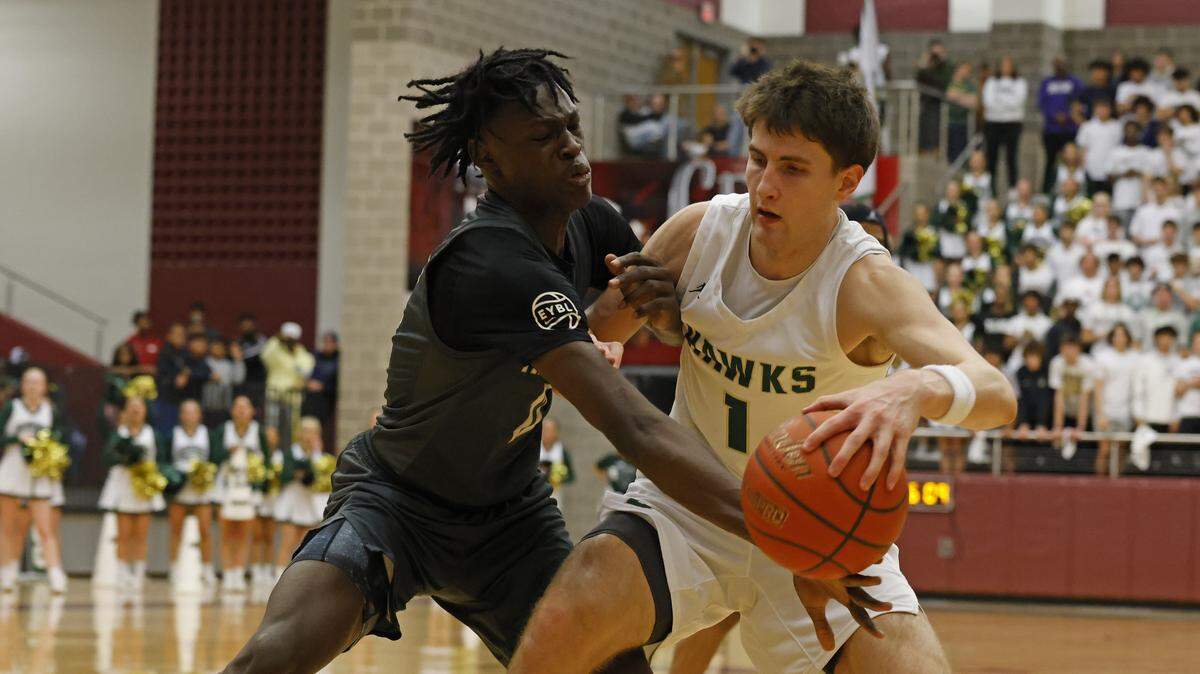 Frisco Heritage forward Bryson Howard (12) reaches in on Birdville forward Sawyer Dotson (1) during the first half of the UIL 5A state semifinal playoff basketball playoff game at Lewisville High School in Lewisville Texas, Tuesday, Mar. 04, 2025.
