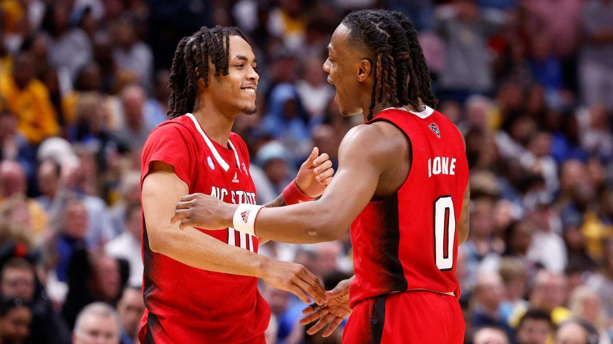 N.C. State’s DJ Horne (0) celebrates with Breon Pass (10) as he comes out of the game late in the second half of N.C. State’s 67-58 victory over Marquette in their NCAA Tournament Sweet 16 game at the American Airlines Center in Dallas, Texas, Friday, March 29, 2024.