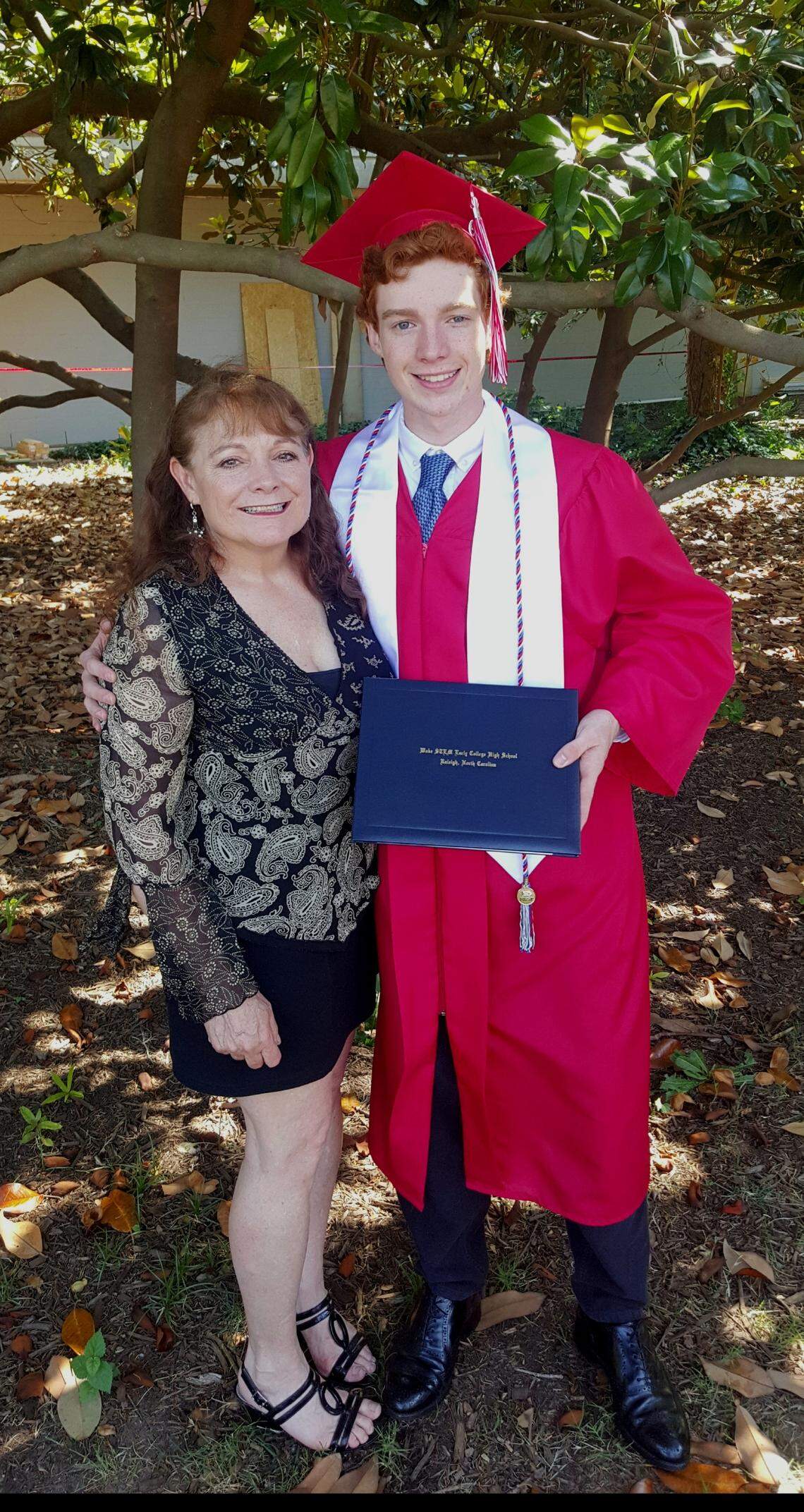 Tamra Demello, left, and Tyler Gilreath at his graduation from Wake STEM Early College High School. Gilreath died Sept. 26, 2021, from complications of COVID-19.