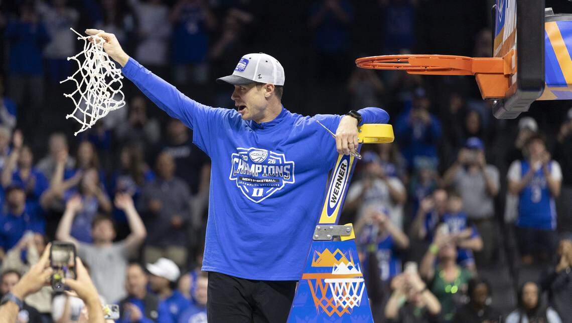 Duke coach Jon Scheyer cuts down the net following the Blue Devils’ 74-70 victory over the Virginia Cavaliers on Saturday, March 14, 2026, during the ACC Tournament Championship at Spectrum Center in Charlotte,  N.C.