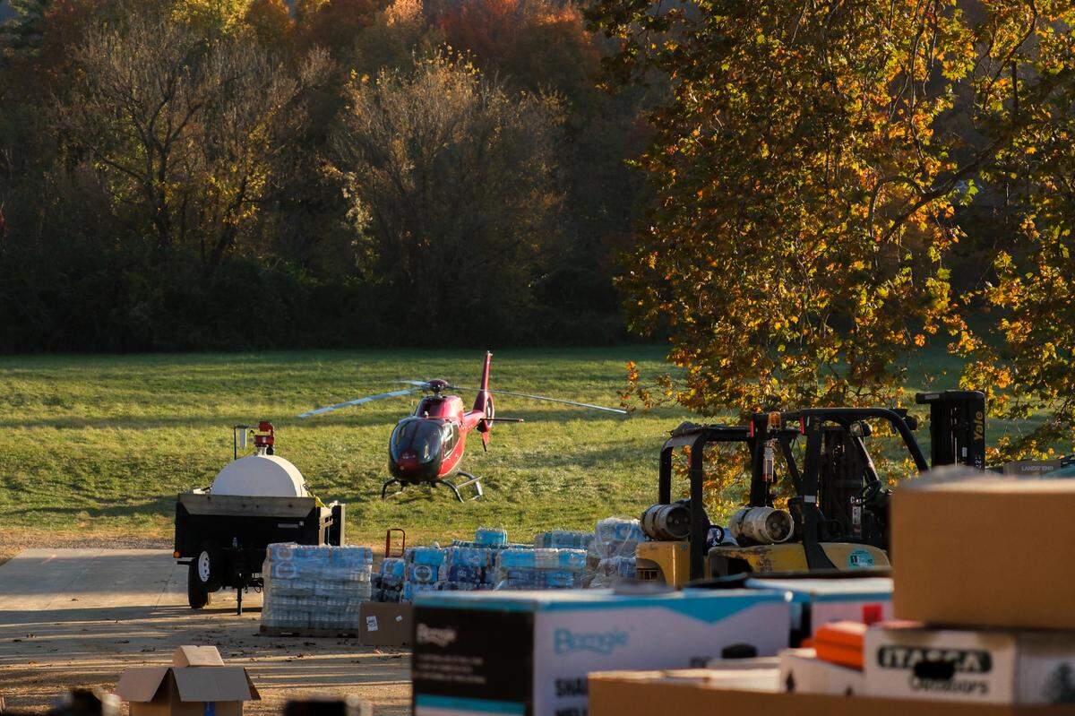 A helicopter sits on the grass near the command center and airfield for Savage Freedoms Relief Operations in Swannanoa, N.C., on Oct. 25, 2024.
