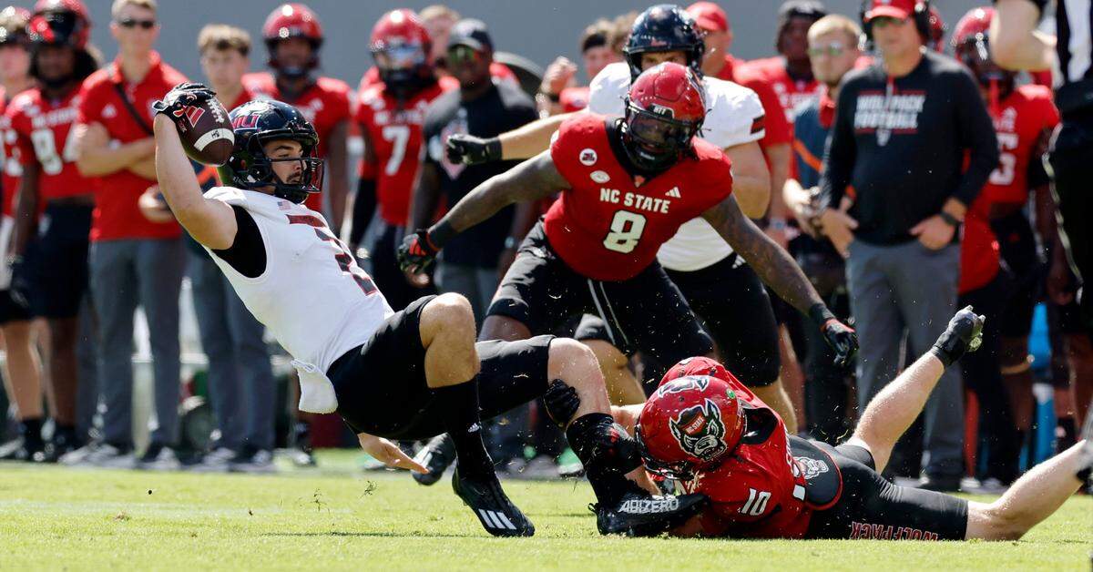 N.C. State linebacker Caden Fordham (10) tackles Northern Illinois quarterback Ethan Hampton (2) during the first half of N.C. State’s game against Northern Illinois at Carter-Finley Stadium in Raleigh, N.C., Saturday, Sept. 28, 2024.