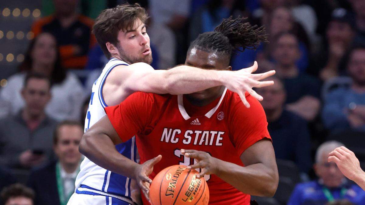 Duke’s Ryan Young (15) defends N.C. State’s DJ Burns Jr. (30) during the first half of N.C. State’s game against Duke in the quarterfinal round of the 2024 ACC Men’s Basketball Tournament at Capital One Arena in Washington, D.C., Thursday, March 14, 2024.