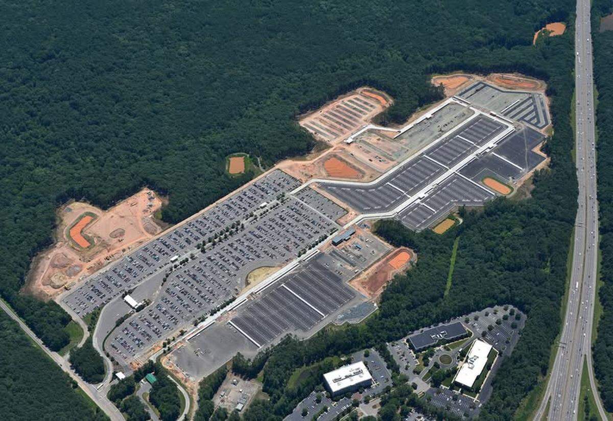 An aerial image of Park Economy 3 at Raleigh-Durham International Airport near Interstate 40, taken in the summer of 2025. The part with cars is the old lot, surrounded by new sections that began to open in June.