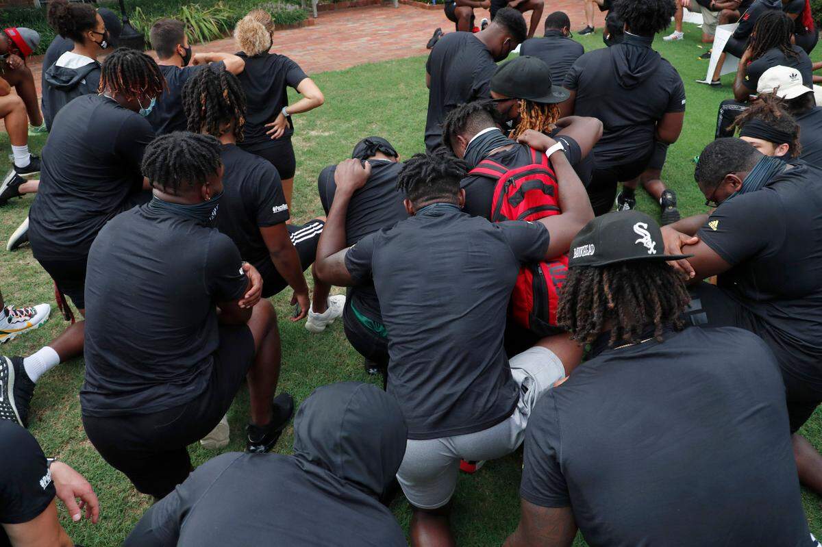 N.C. State athletes, coaches and staff kneel for 8:46, the time police kneeled on George Floyd, during a #PackUnited peaceful protest against racial and social injustice outside Holladay Hall on the campus of N.C. State Saturday, Sept. 12, 2020.