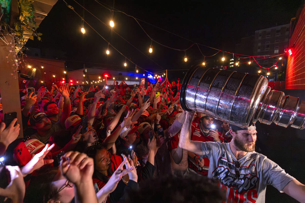Carolina Hurricanes fans celebrate the team's Stanley Cup Final victory at Teets in Raleigh's Glenwood South district as the Stanley Cup, accompanied by Hurricanes players and staff, makes an appearance during a victory celebration Monday, June 15, 2026. The Hurricanes defeated the Vegas Golden Knights 4-2 in the Stanley Cup Final to win the franchise's second championship since 2006.