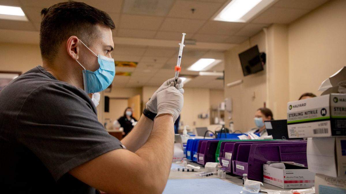 Pharmacist Krishna Rana, prepares doses of the Pfizer COVID-19 vaccine to be distributed at the Durham VA Medical Center during a two-day mass vaccination event where they expected to inoculate 3,000 veterans, on Saturday, Feb. 6, 2021, in Durham, N.C.
