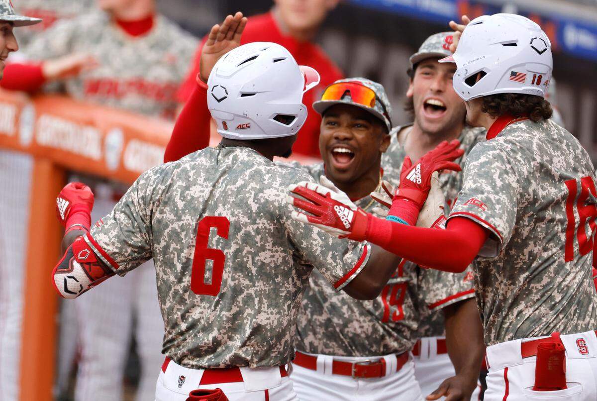 N.C. State’s LuJames Groover III (6) celebrates with teammates after hitting a two-run home run in the first inning during Duke’s game against N.C. State in the ACC Baseball Championship at the Durham Bulls Athletic Park in Durham, N.C., Tuesday, May 23, 2023.