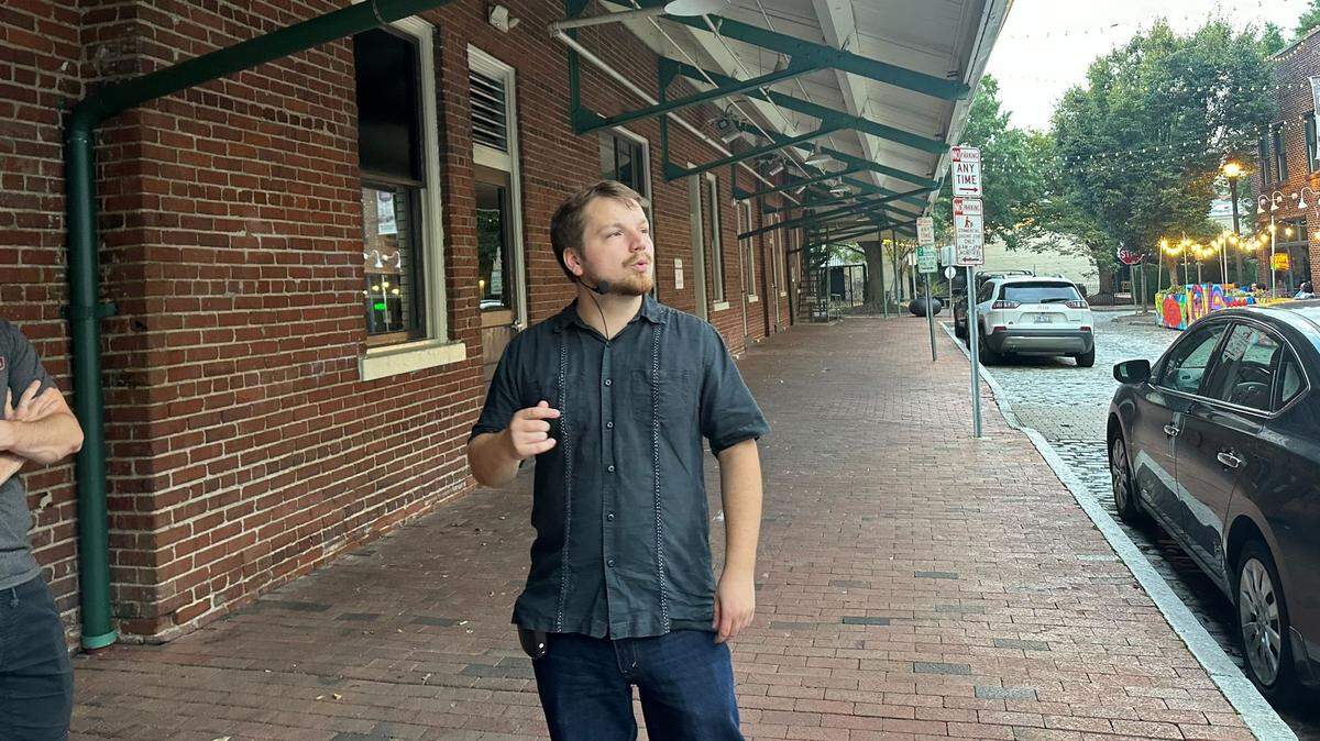 Andrew Nason, 25, stops to talk to clients on his Raleigh True Crime Tour on Sept. 29, 2024. Nason is the founder and operator of Triangle Walking Tours.