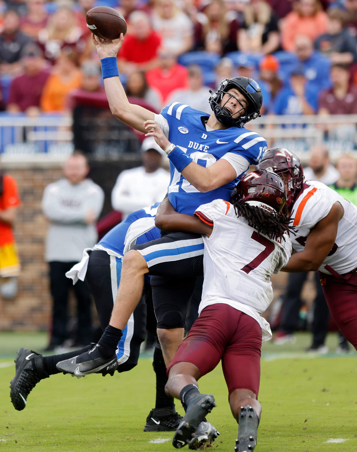 Duke Blue Devils quarterback Riley Leonard is hit by Virginia Tech Hokies linebacker Keonta Jenkins as he throws during the second half of a football game at Wallace Wade Stadium on Saturday, Nov. 12, 2022, in Durham, N.C.