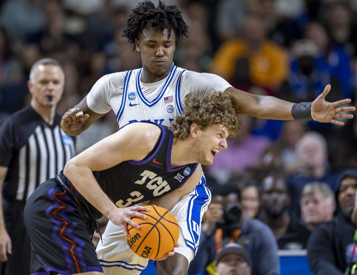 Duke center Patrick Ngongba II (21) defends TCU guard Liutauras Lelevicius (3) in the firsts half on Saturday, March 21, 2026, during the second round of the NCAA Tournament at Bon Secours Arena in Greenville, S.C.