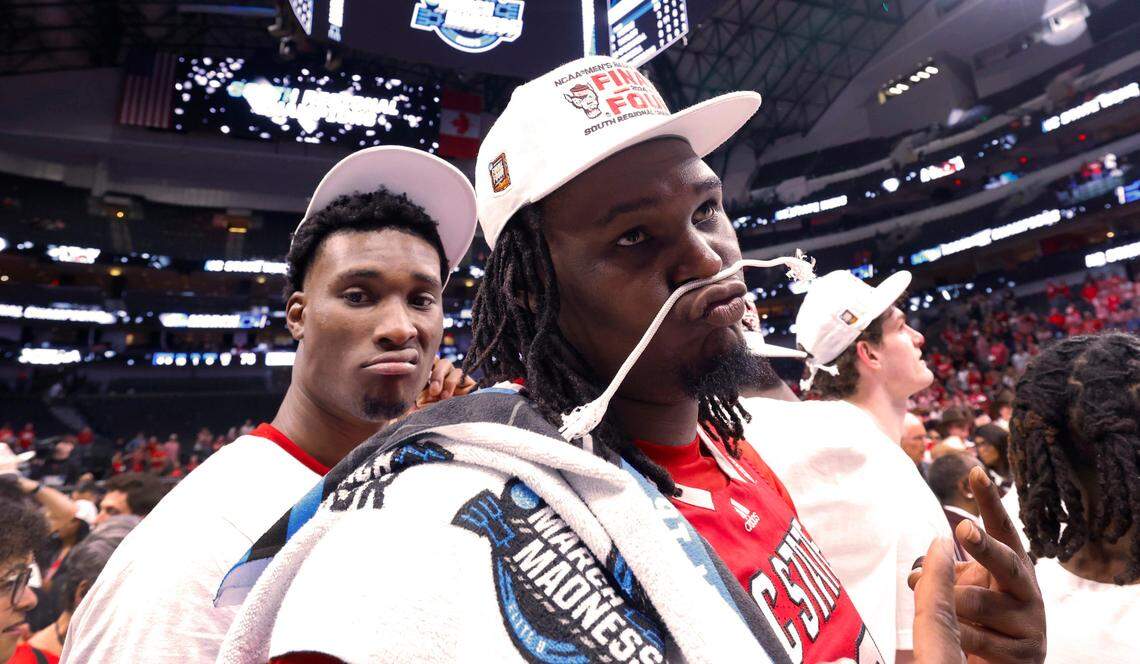 N.C. State’s DJ Burns Jr. (30) and Ernest Ross (24) pose after the Wolfpack’s 76-64 victory over Duke in their NCAA Tournament Elite Eight matchup at the American Airlines Center in Dallas, Texas, Sunday, March 31, 2024.
