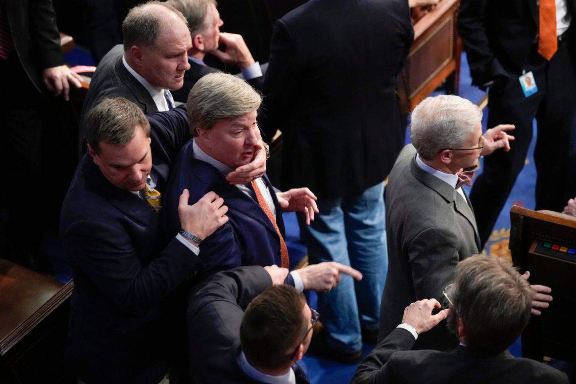 Rep. Richard Hudson, R-N.C., left, pulls Rep. Mike Rogers, R-Ala., back as they talk with Rep. Matt Gaetz, R-Fla., and other during the 14th round of voting for speaker as the House meets for the fourth day to try and elect a speaker and convene the 118th Congress in Washington, Friday, Jan. 6, 2023. At right is Rep. Patrick McHenry, R-N.C.