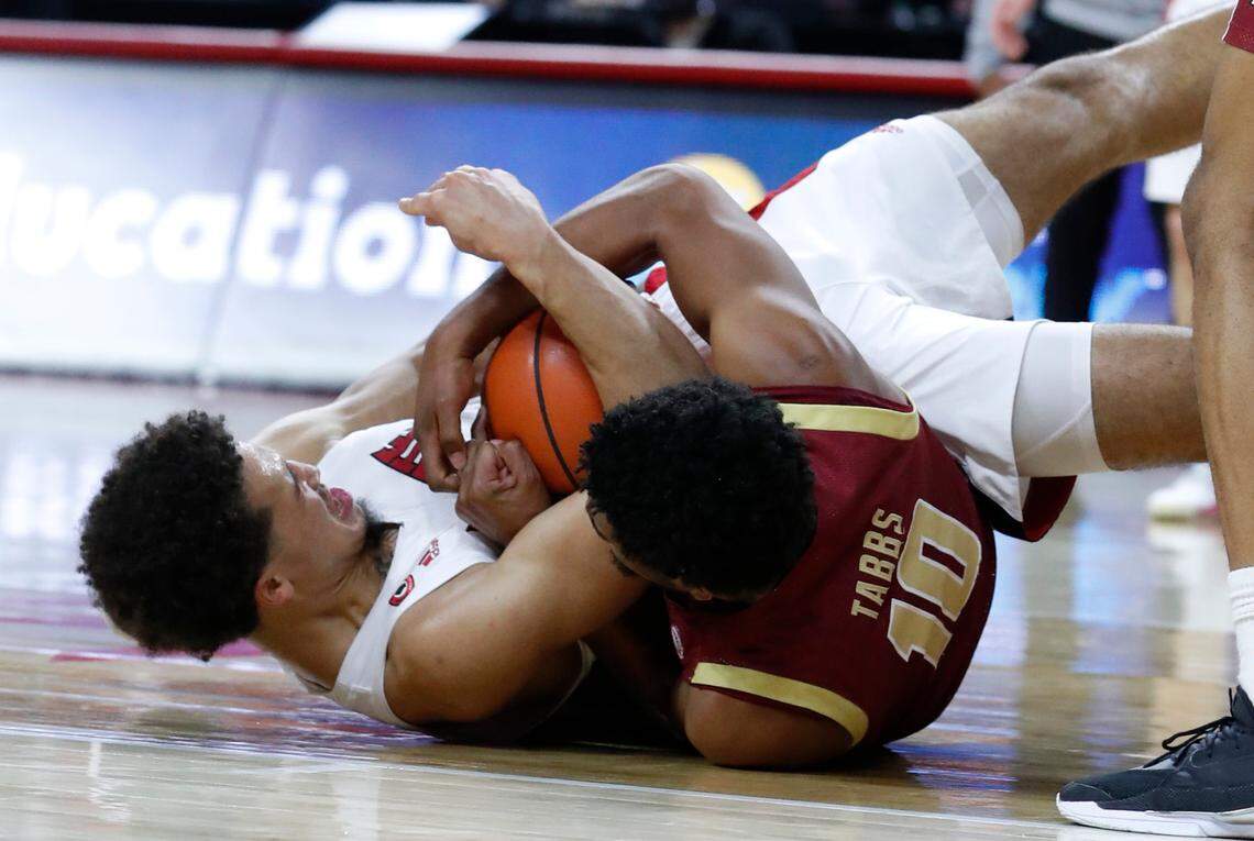 N.C. State’s Jericole Hellems (4) fights with Boston College’s Wynston Tabbs (10) for a loose ball during the second half of N.C. State’s 79-76 victory over Boston College at PNC Arena in Raleigh, N.C., Wednesday, December 30, 2020.