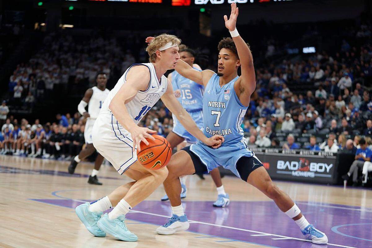 Richie Saunders (15) of BYU drives into Seth Trimble (7) of UNC during the first half of their exhibition game at the Delta Center on October 24, 2025 in Salt Lake City, Utah.