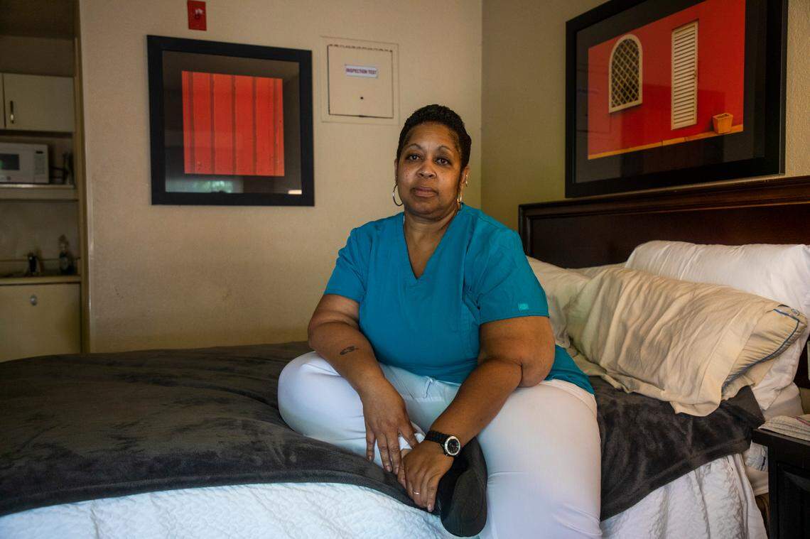 Catrice Otengo sits for a portrait in the hotel room she is renting following an eviction from her previous landlord during the coronavirus pandemic, on Friday, July 31, 2020, in Greensboro, N.C.