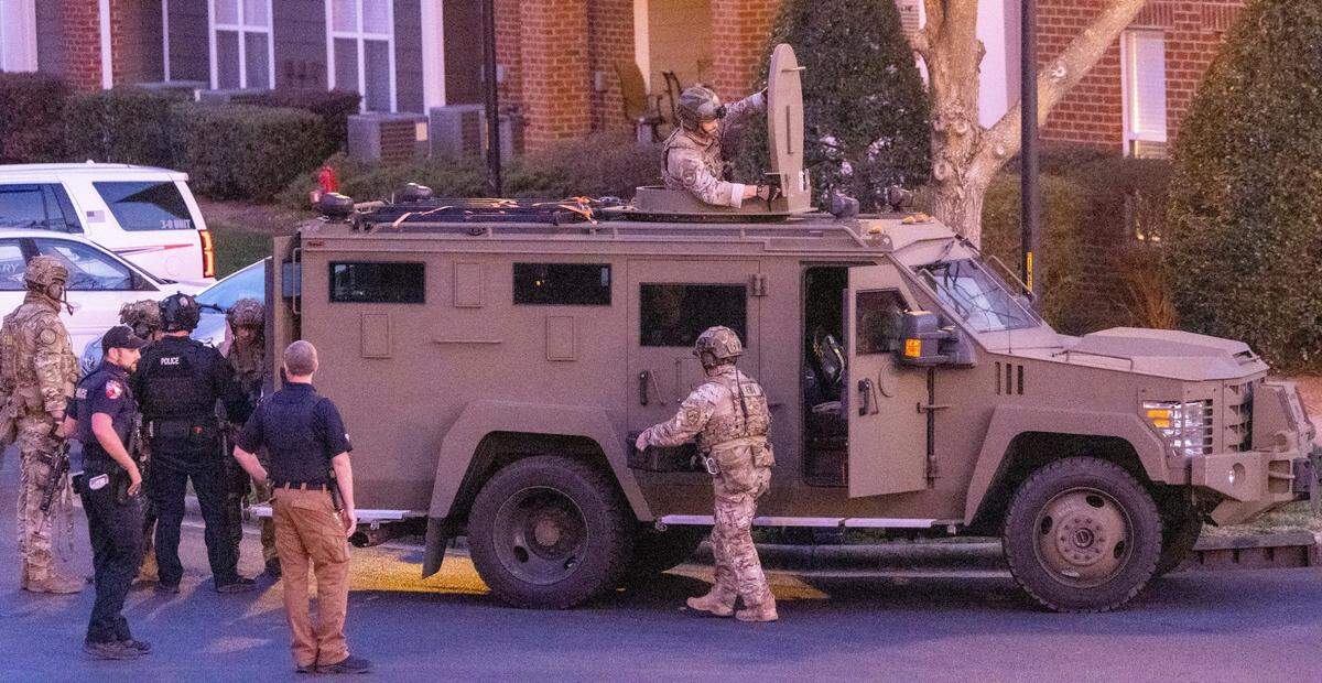 FBI agents and police work the scene of a standoff at Tryon Villages apartments Wednesday, Feb. 22, 2023.