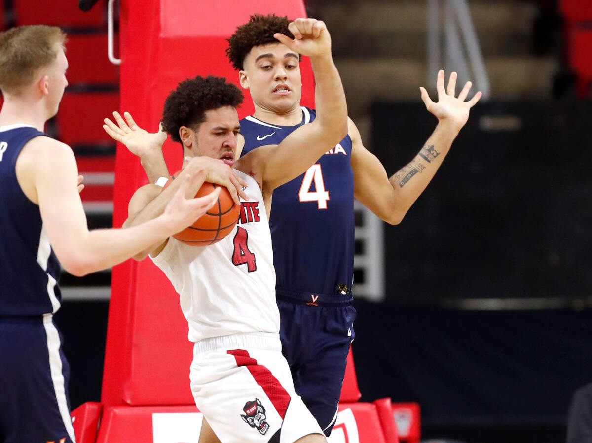 N.C. State’s Jericole Hellems (4) pulls in the rebound from Virginia’s Justin McKoy (4) during the second half of Virginia’s 64-57 victory over N.C. State at PNC Arena in Raleigh, N.C., Wednesday, February 3, 2021.