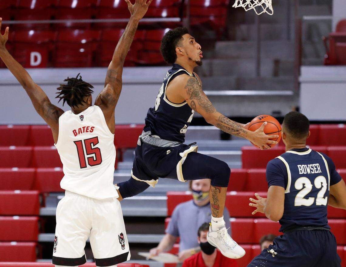 Charleston Southern’s Sean Price (23) shoots as he drives past N.C. State’s Manny Bates (15) during the second half of N.C. State’s 95-61 victory over Charleston Southern in the Wolfpack Invitational at Reynolds Coliseum in Raleigh, N.C., Wednesday, Nov. 25, 2020.