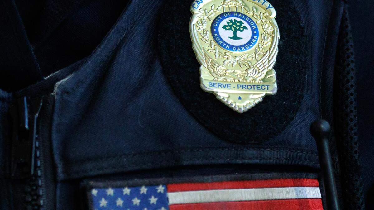 A person wears a Raleigh Police Department badge during a promotion ceremony on Friday, May 23, 2025, at Providence Church in Raleigh, N.C.
