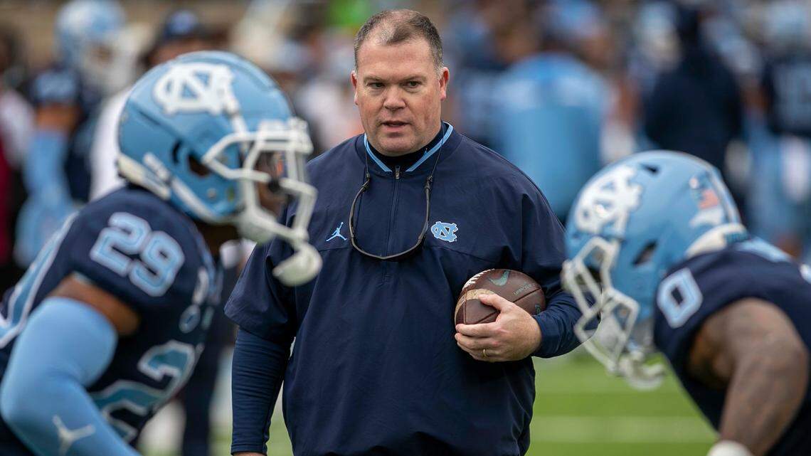North Carolina defensive coordinator Jay Bateman works with Storm Duck (29) and Ja’Qurious Conley (0) as they warm up for their game against Wake Forest on Saturday, November 6, 2021 at Kenan Stadium in Chapel Hill, N.C.