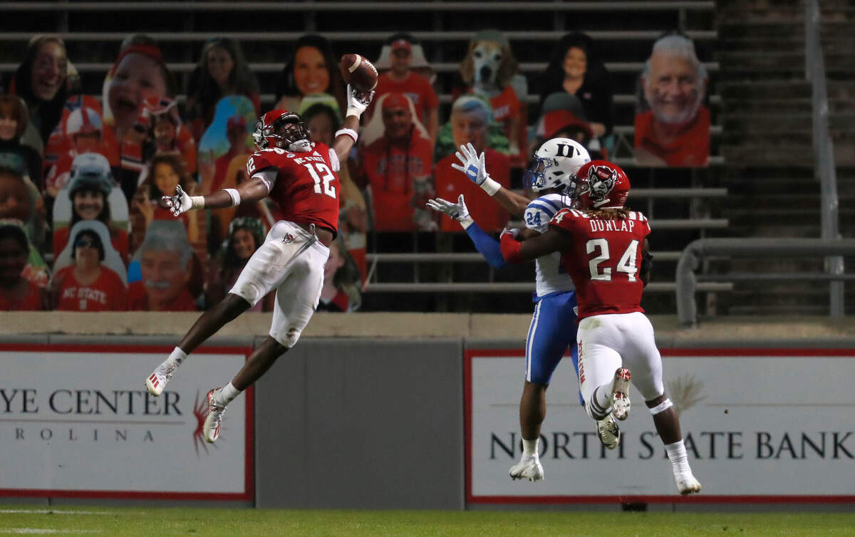 N.C. State’s Devan Boykin (12) breaks up a pass intended for Duke wide receiver Jarett Garner (24) as cornerback Malik Dunlap (24) also defends during the second half of N.C. State’s 31-20 victory over Duke at Carter-Finley Stadium in Raleigh, N.C., Saturday, Oct. 17, 2020.