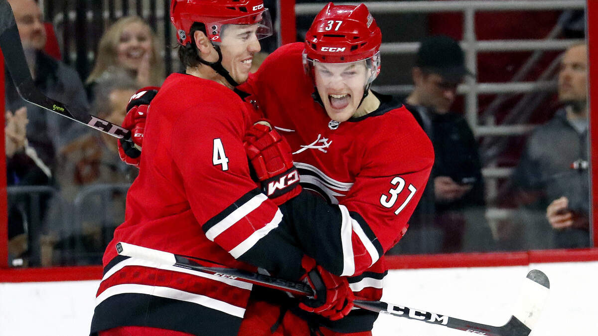 The Canes’ Warren Foegele (37), shown celebrating first NHL goal last season with Haydn Fleury, remains on the Canes’ preseason training camp.