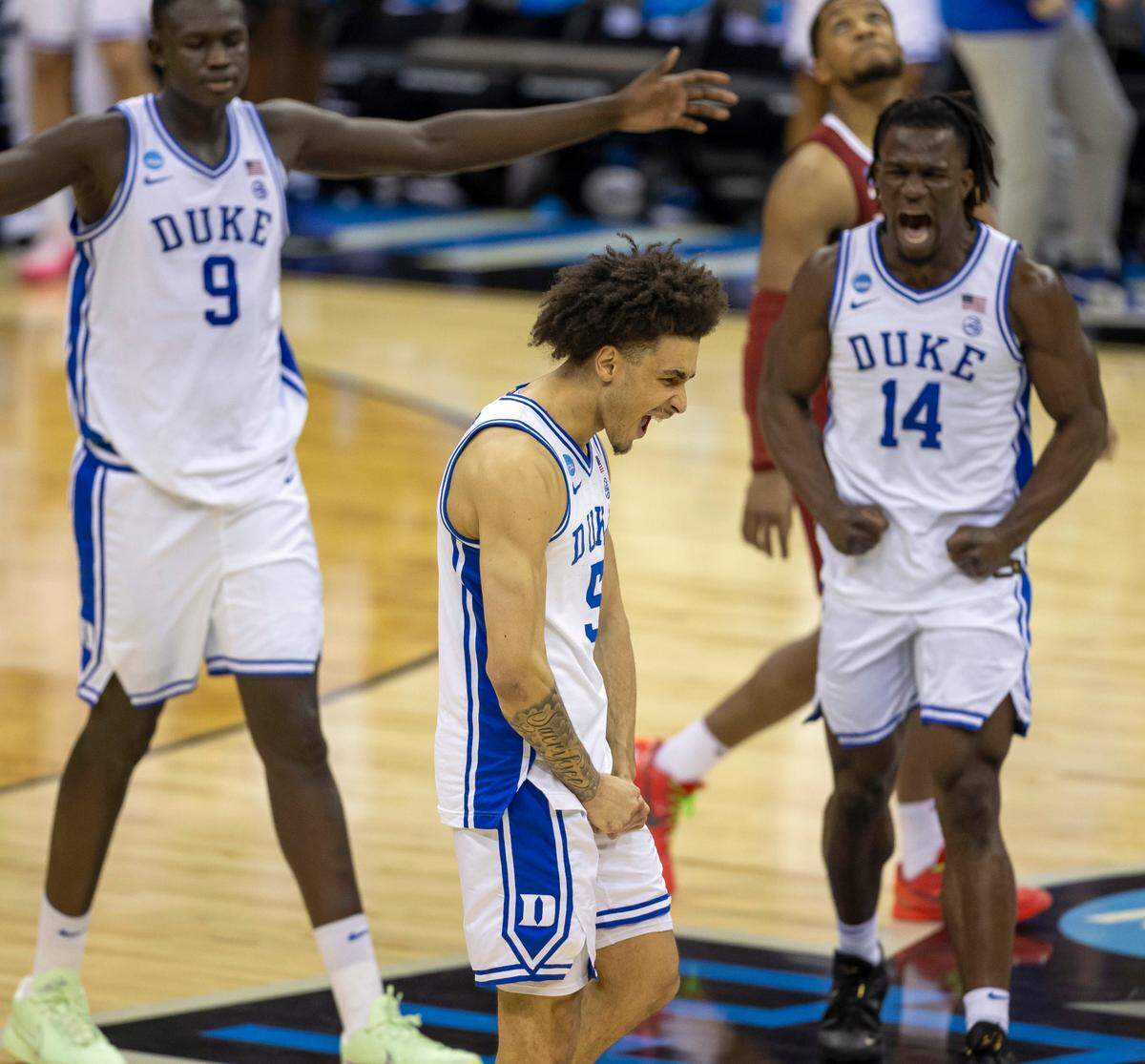 Duke guard Tyrese Proctor (5), Khaman Maluach and Sion James (14) react as time expires and the Blue Devils defeat Alabama on Saturday, March 29, 2025 during the NCAA East Regional final at Prudential Center in Newark, N.J.