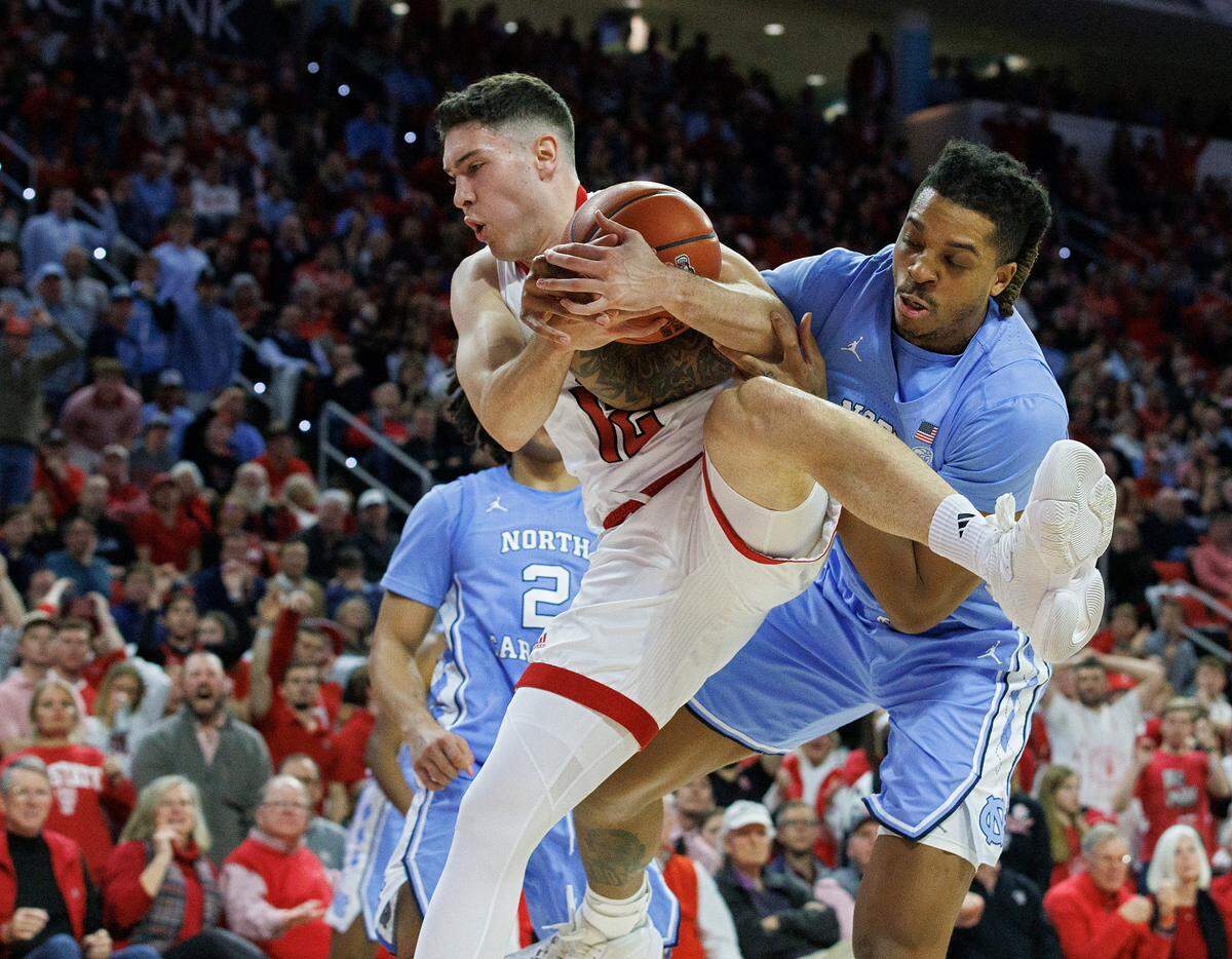 N.C. State’s Michael O’Connell and North Carolina’s Armando Bacot battle for a rebound during the second half of the Tar Heels’ 67-54 win at PNC Arena on Wednesday, Jan. 10, 2024, in Raleigh, N.C.