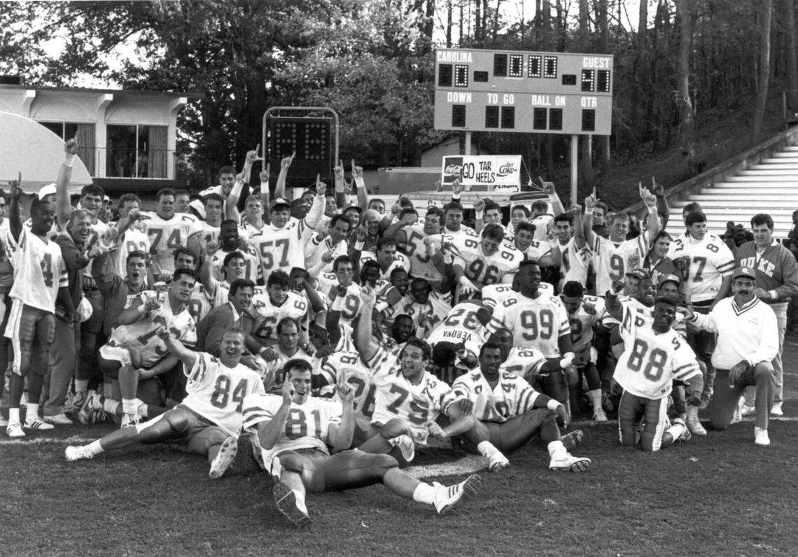 Duke football caoch Steve Spurrier and his team pose in frontot of the scorebaord after defeating the UNC Tar Heels 41-0 in Kenan Stadium November 18, 1989. Courtesy of the Duke Sports Information. 