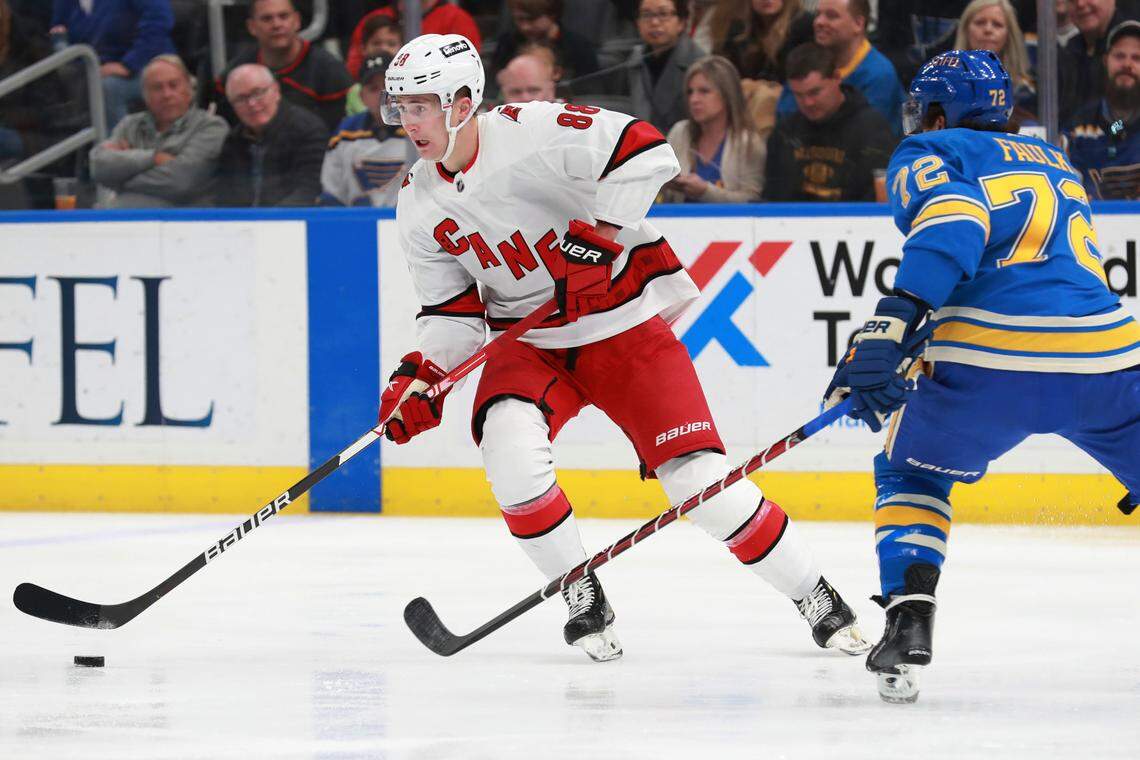 Carolina Hurricanes’ Martin Necas (88) works the puck against St. Louis Blues’ Justin Faulk (72) during the first period of an NHL hockey game against the St. Louis Blues on Saturday, March 26, 2022 in St. Louis. (AP Photo/Michael Thomas)