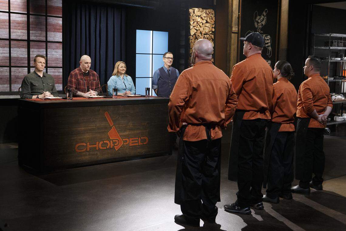 Judges Marc Murphy, Chris Santos and Elizabeth Karmel and host Ted Allen face chefs Christopher Prieto, Melanie Dunia, Adam Hughes and Jerry Stephenson during the appetizer round tasting, as seen on Chopped, Grill Masters Special.