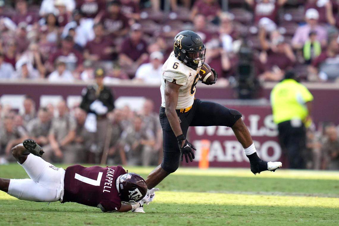 Appalachian State running back Camerun Peoples (6) steps out of a tackle by Texas A&M defensive back Tyreek Chappell (7) for a first down run nearing the end of the fourth quarter during an NCAA college football game Saturday, Sept. 10, 2022, in College Station, Texas. (AP Photo/Sam Craft)